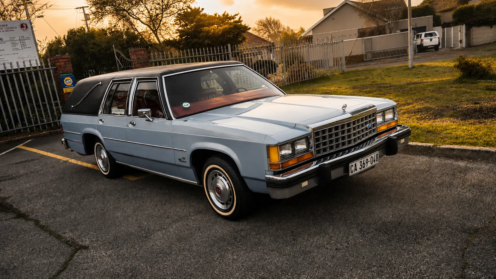 The WS Engledoe & Sons hearse, a classic Ford, parked outside a Cape Town church at sunset